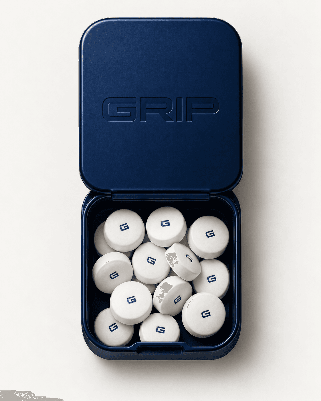 Open navy Grip tin with white pills
